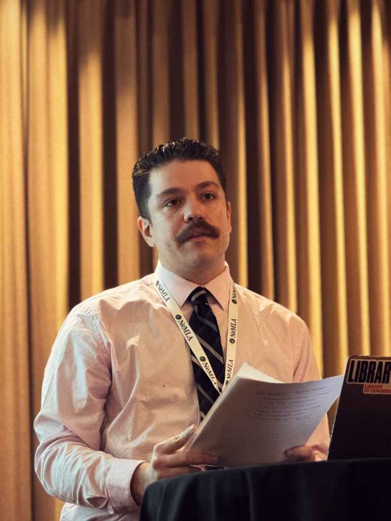 Anthony Gottlich delivering a conference paper at NEMLA 2026 (the Northeast Modern Language Association conference).